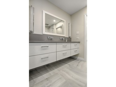 1st place, bathroom, contemporary/modern, $25,000-$39,999: Shannon Callaghan of Copperstone Kitchens used floating cabinetry and an under-mounted trough sink with two wall faucets to emphasize the simplicity and balance of this bathroom.