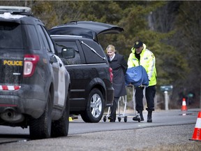 The body of Chris Walsh is removed from the scene on Russett Drive just outside of Arnprior after being discovered early in the morning on Saturday, April 2, 2016.