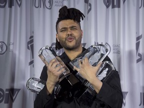 The Weeknd holds five Juno trophies at the Juno Awards Gala in Calgary, Sunday, April 3, 2016.