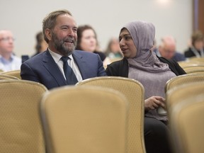 NDP leader Tom Mulcair speaks with a delegate during a session at the Progress summit in Ottawa, Friday April 1, 2016.