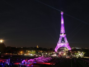 TOPSHOTS A picture taken on September 28, 2015 in Paris, shows the Eiffel Tower illuminated with a pink light, as part of the 'Ruban Rose' event launched by Paris' Mayor, during the 22nd campaign against breast cancer, in honor of National Breast Cancer Awareness Month, part of the Octobre Rose (Pink October).