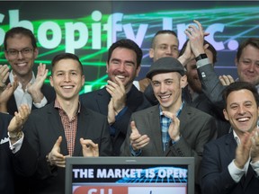 Employees from Shopify ring the bell at the Toronto Stock Exchange in Toronto, Ontario, Tuesday May 26, 2015.