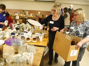 Volunteers Wilma Williamson, second from right, and Deb Aben sort through donated items including food, kitchen items, household goods, new cleaning supplies and new toiletries for the New Canadians Centre's Dishes and Dinner Donation Drive to aid 36 government sponsored refugee families from Syria coming to Peterborough over the next year taking place on Friday April 1, 2016 at St. James United Church in the basement on Romaine St. in Peterborough, Ont. Clifford Skarstedt/Peterborough Examiner/Postmedia Network