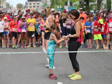 Grace Blahey, left, and Jennifer Blahey warm up prior to the start of the Kids 2K run.