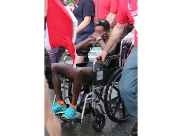 Peres Jepchirchir of Kenya is wheeled off by medical personnel after collapsing following her 10K victory.