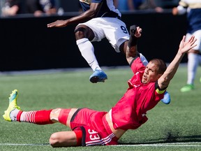 Ottawa Fury FC Rafael Alves slides to defend against Jacksonville Armada FC Charles Eloundou at TD Place on Sunday May 22, 2016.