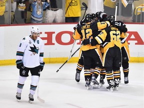 Nick Bonino #13 of the Pittsburgh Penguins celebrates with teammates after scoring a third period goal against the San Jose Sharks as Joe Pavelski #8 reacts in Game One of the 2016 NHL Stanley Cup Final at Consol Energy Center on May 30, 2016 in Pittsburgh, Pennsylvania.
