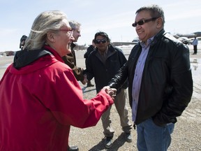 Minister of Indigenous Affairs Carolyn Bennett, left, meets with Chief Bruce Shisheesh, right, in the northern Ontario First Nations reserve in Attawapiskat, Ont., on Monday, April 18, 2016.