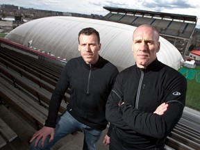 In a 2009 file photo, Martin Lauter, left, and Ian Martin of Coliseum Inc. stand in front of their dome at Lansdowne Park.