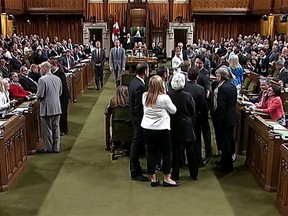 Canadian Prime Minister Justin Trudeau, face towards the camera left of centre of the frame, is shown near Opposition whip Gordon Brown in the House of Commons in Ottawa on Wednesday May 18, 2016. Footage from the Commons television feed shows Trudeau wading into a clutch of MPs, mostly New Democrats, and pulling Opposition whip Gordon Brown through the crowd in order to get a vote started. THE CANADIAN PRESS/HO-House of Commons **MANDATORY CREDIT** ORG XMIT: CPT180
