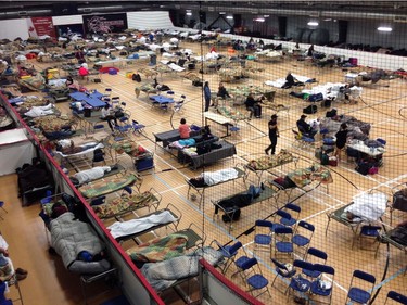 Cots litter the gym floor at an evacuee reception centre set up and operated by the regional municipality of Wood Buffalo in Anzac, Alta., on Wednesday, May 4, 2016. Raging forest fires whipped up by shifting winds sliced through the middle of the remote oilsands hub city of Fort McMurray Tuesday, sending tens of thousands fleeing in both directions and prompting the evacuation of the entire city.