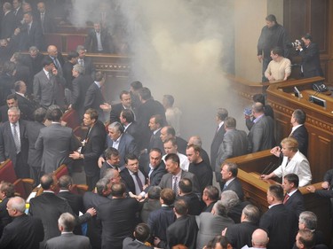 Deputies of Ukraine's parliament fight during a parliament sitting in Kiev on April 27,  2010. Fighting broke out and smoke bombs were thrown Tuesday as Ukraine's parliament erupted into chaos as it ratified a bitterly controversial deal with Russia extending the lease of a key naval base..Russia's lower house of parliament on Tuesday unanimoulsy ratified a deal with Ukraine to extend the lease of the Russian Black Sea Fleet on a base in Crimea until at least 2042.