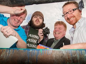 Eco-artists and upcycling entrepreneurs ham it up in a dumpster behind their Ottawa warehouse. The crew make artisan pieces and useable items from trash they collect. Left to right are: Justin Maheux, Michael Grant, Darcy Whyte and Chris Ziraldo.