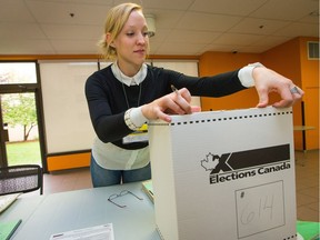 Election worker Katie Dudzik closes up a ballot box while helping to prepare for advance polls for the Oct. 19, 2015 federal election.