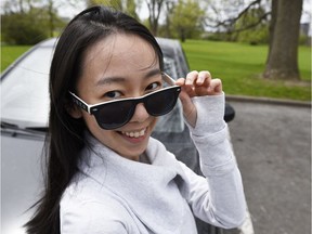 Ingrid Goddard, 41, has been driving for Uber since last August. She is one of the roughly 500 women who drive for the ride-ordering company in Ottawa, a city that rarely sees women drive taxis. She is photographed with her car she uses for Uber in Ottawa Thursday May 12, 2016