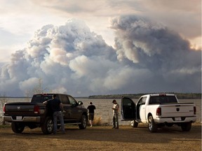 Evacuees watch the wildfire ne Fort McMurray, Alta., on Wednesday May 4, 2016.