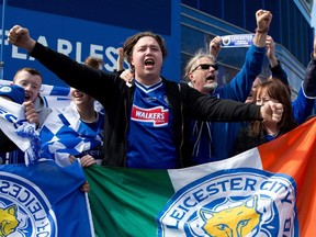 Leicester City football fans celebrate outside the King Power Stadium in Leicester, central England.