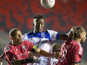 Fury defender Rafael Alves (L) and Edmonton Pape Diakité (c) go for the ball with Fury player James Bailey (R) in close in the second half as Ottawa Fury FC take on FC Edmonton at TD Place stadium. (WAYNE CUDDINGTON) Assignment - 123618