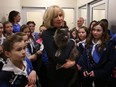 Girl Guides look on as Laureen Harper holds a cat named Diamond at the Ottawa Humane Society in early 2015.