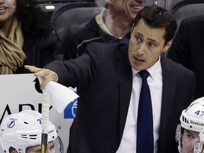 FILE - In this Feb. 24, 2013, file photo, Tampa Bay Lightning head coach Guy Boucher gives instructions from behind his bench in the first period of an NHL hockey game against the Pittsburgh Penguins in Pittsburgh. Boucher has been hired as the new head coach of the Ottawa Senators on Sunday, May 8, 2016.