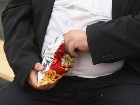 A man eats junk food in Leipzig, Germany.