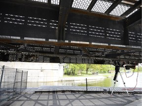 A worker works on repairs to the locks at the Hog's Back Road bridge on Saturday.