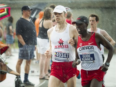 Ottawa's Jason Dunkerley with his guide runner during the 10K.
