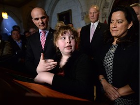 Charlie Lowthian-Rickert, who is transgender, speaks along side Justice Minister Jody Wilson-Raybould, right, as she makes an announcement in the foyer of the house of commons on Parliament Hill in Ottawa on Tuesday, May 17, 2016, regarding legislation on gender identity and gender expression.