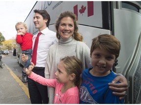 Justin Trudeau, his wife Sophie Gregoire Trudeau and children Hadrien, Ella-Grace and Xavier pose for photographers before boading the campaign bus after voting in Montreal, Monday, October 19, 2015. The opposition parties are making some political hay over media reports that Prime Minister Justin Trudeau's wife wants extra staff to help manage her official duties.