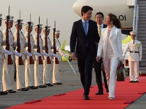 Prime Minister Justin Trudeau and wife Sophie Grégoire Trudeau are greeted by an honour guard as they arrive in Tokyo, Japan on Monday, May 23, 2016. One letter-writer says they should have been paying attention to the guards, not each other.