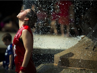 Kati Kaubisch cools off in the fountain in Confederation Park after finishing the 2K race on Tamarack Ottawa Race Weekend on Saturday, May 28, 2016.