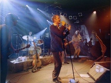 The Tragically Hip perform at a concert in a Kingston bar in 1998.  It was the first of four concerts in secret locations the Hip are performing to benefit Camp Trillium, for children with cancer. Gord Downie sings a song with Paul Langlois (L) Johhn Fay, on drums and Rob Baker (right) Gord Sinclair is behind Downie.