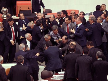 Lawmakers from the main opposition Republican People's Party and ruling Justice and Development Party fight during a debate at the parliament in Ankara, Turkey, late Thursday, Feb. 19, 2015. A proposed security bill that would expand Turkish police powers to crackdown on demonstrators has blown up a debate over the government's burgeoning means to quash dissent.