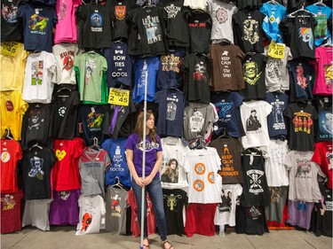 Madison Adams, 21, waits for customers to buy T-shirts as Ottawa Comiccon 2016 got underway at the EY Centre.