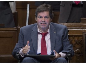 Ottawa-Vanier MP Mauril Belanger gives the thumbs up as he receives applause after using a tablet with text-to-speech program to defend his proposed changes to neutralize gender in the lyrics to "O Canada" in the House of Commons on Parliament Hill in Ottawa on Friday, May 6, 2016.