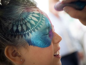 Nine-year-old Jade Fried gets her face painted by Kromatic extreme makeup at the Ottawa Children's Festival at Lebreton Flats Park in front of the Canadian War Museum Saturday.
