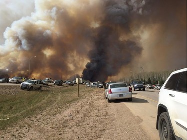 Abandoned vehicles litter Highway 63, south of Fort McMurray, Alta., as residents fled the wildfire engulfing the city on Tuesday, May 2, 2016. Fuel shortages are being reported in the evacuation area.