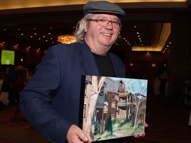 Ottawa artist Russ Paquette donated one of his paintings, Autumn in the Glebe, to the silent auction at the 17th annual Spring into Motion charity auction and dinner for The Rehabilitation Centre Volunteer Association, held at the St. Elias Centre on Wednesday, May 18, 2016.