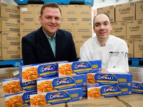 Left, Ottawa Food Bank executive director Michael Maidment and National Arts Centre executive sous chef Martin Levesque with some of the 9,120 boxes of Catelli pasta that was donated to the Ottawa Food Bank.
