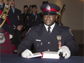 Const. Christian Nungisa receives his wallet badges at a 2013 ceremony. ( Chris Mikula / Ottawa Citizen)
