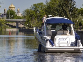 A boat makes its way through the Hog's Back locks on the Rideau Canal.