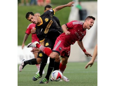 Ottawa's Carl Haworth gets on top of the ball, ahead of Fort Lauderdale's Luis Felipe Fernandes, but suffers a fall.