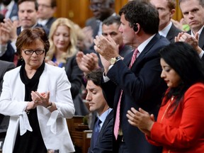 Prime Minister Justin Trudeau, centre, is applauded by members of the Liberal party after addressing the House of Commons on Parliament Hill in Ottawa on Thursday, May 19, 2016. Trudeau apologized for his conduct following an incident in the House Wednesday when he pulled Conservative whip Gord Brown through a clutch of New Democrat MPs to hurry up a vote related to doctor-assisted dying.