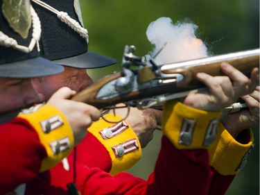 Re-enactors from the 100th Regiment of Foot, L-R Private Max Cronkite and Private Richard Beaudin, were demonstrating the steps for firing a 19th century musket at the Canadian War Museum Sunday May 29, 2016.   Ashley Fraser
