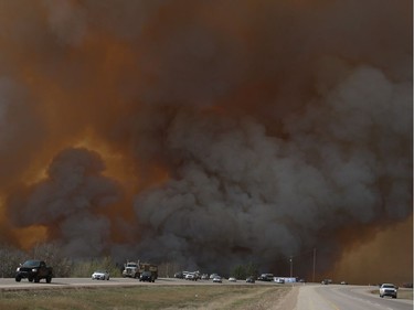 Residents of Fort McMurray flee southbound on Highway 63 Tuesday. Wildfires forced the evacuation of the city Tuesday as high temperatures and winds continued to batter the region. Robert Murray/Fort McMurray Today/Postmedia Network ORG XMIT: POS1605032035462206