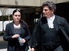 Roxanne Carr leaves the Ottawa courthouse with her lawyer Lawrence Greenspon during a break in proceedings on Wednesday.