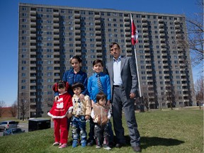 Shikh Omar Jalal, with his children Hala, 11, Eman, 9, Jona, 5, Yosiv, 3, and Majad, 2 in front of their apartment building on Donald Street, where about 400 Syrian refugees have settled.