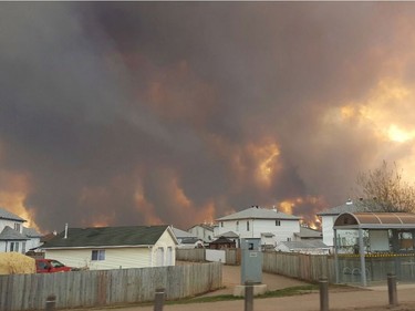 Smoke rises from a wildfire outside of Fort McMurray, Alberta, Tuesday, May 3, 2016. The entire population of the Canadian oil sands city of Fort McMurray, has been ordered to evacuate as a wildfire whipped by winds engulfed homes and sent ash raining down on residents. (Mary Anne Sexsmith-Segato/The Canadian Press via AP) MANDATORY CREDIT ORG XMIT: CPT504