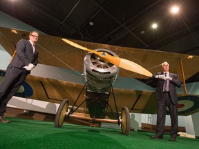 Stephen Quick, (R) Director General of the Canadian War Museum and Chris Kitzan, (L) Director General of the Canada Aviation and Space Museum, help move the Sopwith Pup into place that is the centrepiece of a new display at the Canadian War Museum that will be formally unveiled to the public on June 9th.