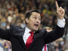 Team Canada's head coach Guy Boucher reacts during the match between Switzerland's HC Davos and Team Canada at the 89th Spengler Cup hockey tournament in Davos, Switzerland, Wednesday, Dec. 30, 2015. Boucher has been hired as the new head coach of the Ottawa Senators.